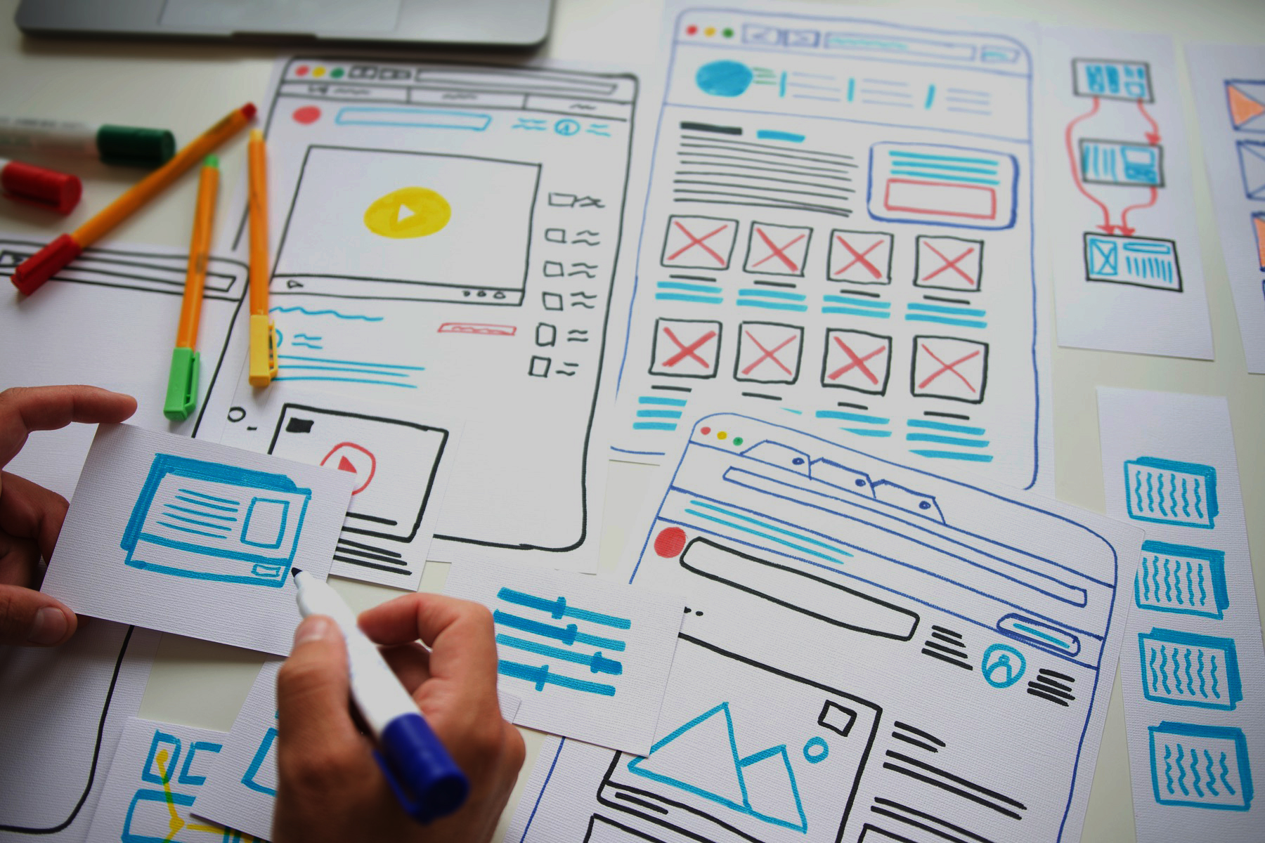 Website layouts being sketched and planned